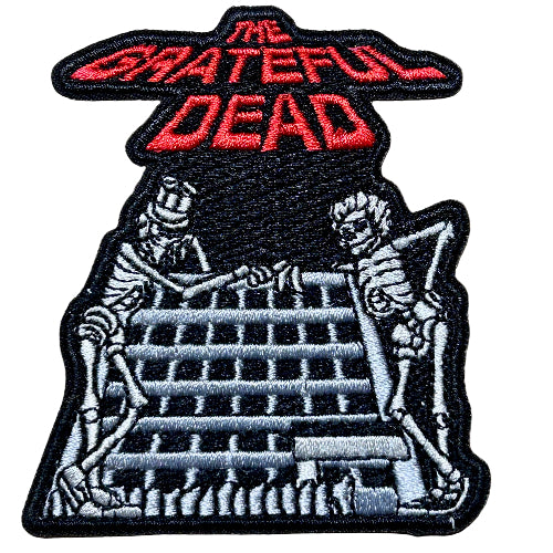 Embroidered patch with 'The Grateful Dead' logo and skeletons on stairs.