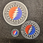 Three embroidered patches with a prominent 'International Brotherhood of Grateful Dead' logo on a dark fabric background.