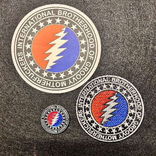 Three embroidered patches with a prominent 'International Brotherhood of Grateful Dead' logo on a dark fabric background.