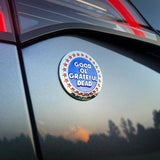 Sticker with 'Good Ol' Grateful Dead' text on a car window at sunset.