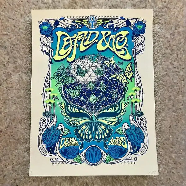 Psychedelic concert poster featuring a geometric Grateful Dead skull design in blue and green tones with ornate Art Nouveau-style decorative elements.