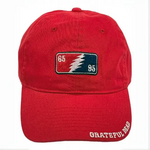 Red baseball cap with a Grateful Dead lightning bolt patch and embroidered text.