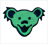 Green embroidered patch featuring the iconic smiling bear face with black outlines and details.