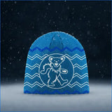 Blue knitted beanie featuring a white embroidered grateful dead dancing bear logo surrounded by zigzag patterns.