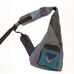 Multi-colored crossbody sling bag with a bird design patch on the front pocket.