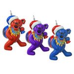 Three colorful bear ornaments with Santa hats on a white background