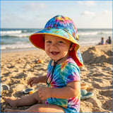 A vibrant tie-dye grateful dead toddler sun hat with wide brim red lining and dancing bears cartoon design for beach use