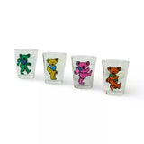 Four shot glasses decorated with colorful dancing bear designs.