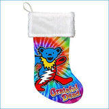 A festive holiday stocking featuring a vibrant tie-dye design with the iconic blue grateful dead bear mascot and ’grateful dead’ text in bold red lettering, accented by a plush white cuff.