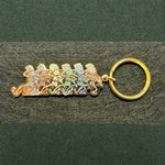 Gold-toned keychain featuring a row of running stick figures in pastel colors.