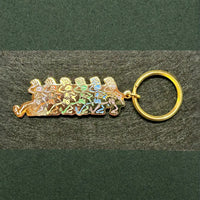 Gold-toned keychain featuring a row of running stick figures in pastel colors.