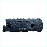 Dark gray textured enamel pin shaped like a knife with two black rivets and the text ’030/100’’ printed below.