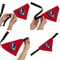 Red triangle-shaped pet accessory with a logo, held by hands against a white background