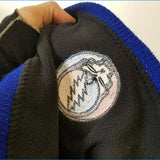 Black fleece hoodie with blue ribbed trim and a circular embroidered patch featuring the grateful dead lightning bolt logo.