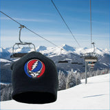 Black knit beanie featuring a circular embroidered patch with the iconic red, white, and blue grateful dead skull logo.