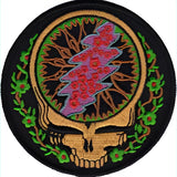 A circular embroidered patch featuring the iconic grateful dead skull design with a lightning bolt, adorned in vibrant pink and purple hues against a black background.