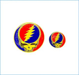 Golden-rimmed circular pins featuring the iconic grateful dead skull design with a red, blue, and yellow lightning bolt.