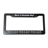 Black license plate frame with 'Have A Grateful Day!' text on a white background