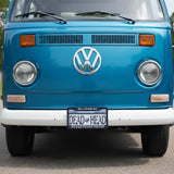 Front view of a blue Volkswagen van with a 'Dead Head' license plate.