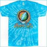 A blue tie-dye Grateful Dead t-shirt featuring the iconic Grateful Dead skull and lightning-bolt logo in the center, with 'Grateful Dead' text below it, laid flat against a white background.