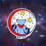 A circular sticker featuring a light blue grateful dead bear wearing a red scarf, standing on a crescent moon with yellow stars hanging above it.