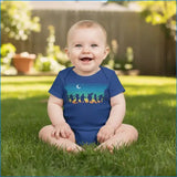 Baby sitting on grass wearing a blue onesie with a colorful design.