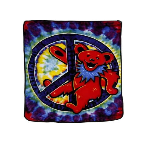 Tie-dye blanket with a red bear and peace symbol design on a white background