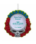 Decorative ornament with skull design and red roses on a white background