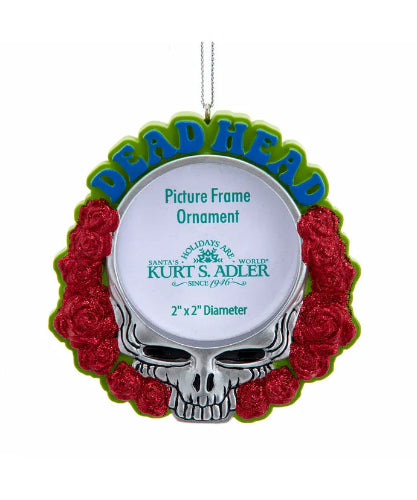 Decorative ornament with skull design and red roses on a white background