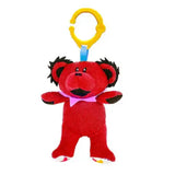 Red bear plush toy with a yellow clip on a white background