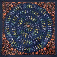 Spiral pattern bandana with dancing skeleton designs in blue, yellow and orange tones.