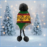 Green and yellow grateful dead-themed dog sweater with red trim and black pom-pom feet.