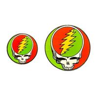 Two Grateful Dead logo pins with a skull and lightning bolt on a dark background
