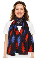 Woman wearing a colorful scarf with red and blue patterns on a white background
