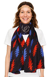 Woman wearing a colorful scarf with red and blue patterns on a white background