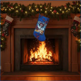 Blue Christmas stocking hanging above a fireplace with stockings on either side.
