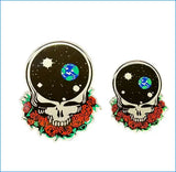 Two circular stickers featuring a black skull design with earth and stars inside the head, surrounded by red roses.