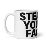 White mug with black text.