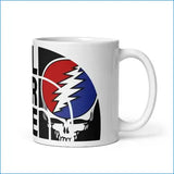 White ceramic mug featuring the iconic grateful dead logo with a red, blue, and white lightning bolt over a skull design.