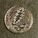 Metallic Grateful Dead ’Steal Your Face’ logo pin with ornate floral patterns and colorful crystal accents.