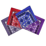 Three colorful playing card boxes stacked on a white background