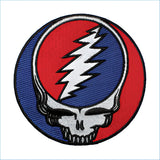 Circular embroidered patch featuring the iconic grateful dead skull design with a red and blue split background, white lightning bolt across the face.
