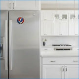 Stainless steel refrigerator with a Grateful Dead sticker in a kitchen setting