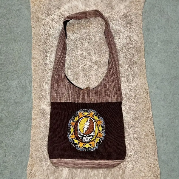 Brown corduroy shoulder bag featuring a Grateful Dead ’Steal Your Face’ logo patch.