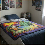 Bedroom with a colorful blanket featuring a turtle design on a bed.