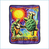 A vibrant, plush blanket featuring two green turtles playing musical instruments against a psychedelic tie-dye background with the grateful dead logo.