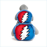 Gray plush shark with two circular red and blue patches featuring a white lightning bolt design on its back.