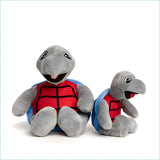 Gray plush turtle stuffed animal wearing a red and blue superhero-style vest
