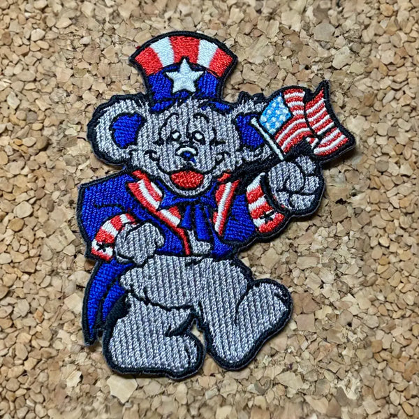 Patriotic cartoon elephant embroidered patch wearing red, white and blue clothing while waving an American flag.