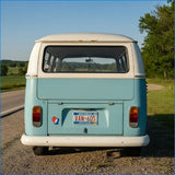 Light blue and white vintage volkswagen van with a wisconsin license plate.